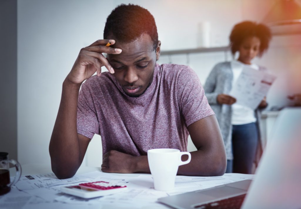 Visualizes the concept of worrying about a loan after coronavirus is over The image aims to portray a Nigerian thinking about his finances.
